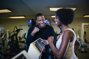 Personal trainer motivating woman on treadmill