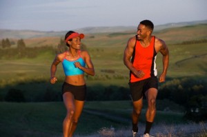 Young couple running in landscape, Othello, Washington, USA