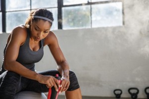 Fit woman taking a break while sitting on fitness ball